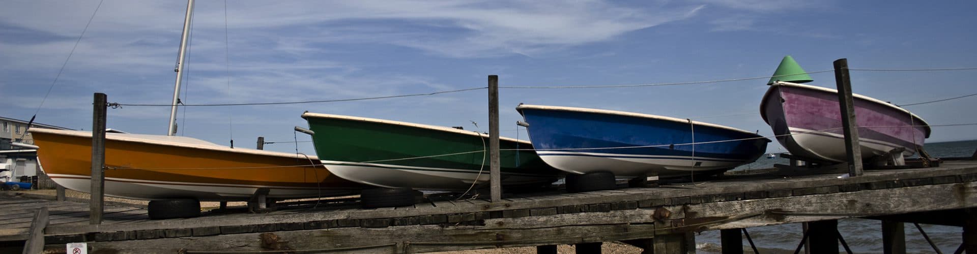 Boats moored in a marina at sunset